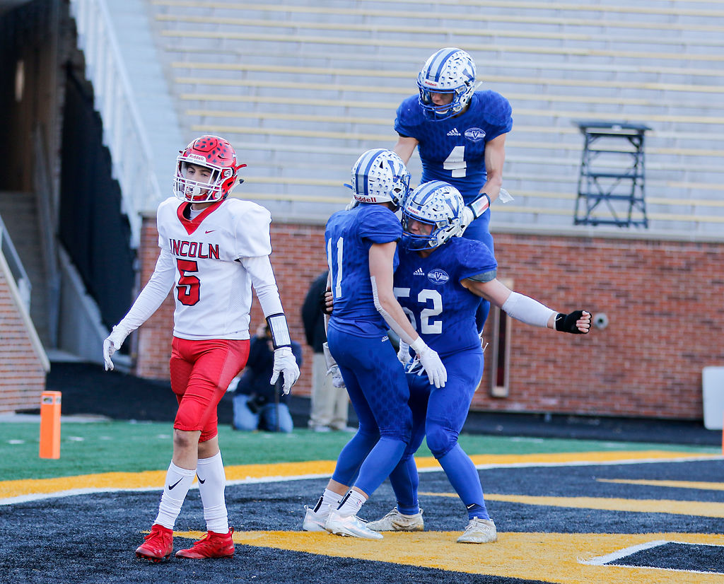Valle athletes Aiden Heberlie (11), Joseph Williams (52) and Jayden Gegg (4) celebrate a touchdown